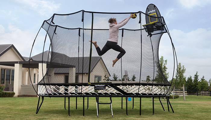 a maom doing slam dunk in a trampoline