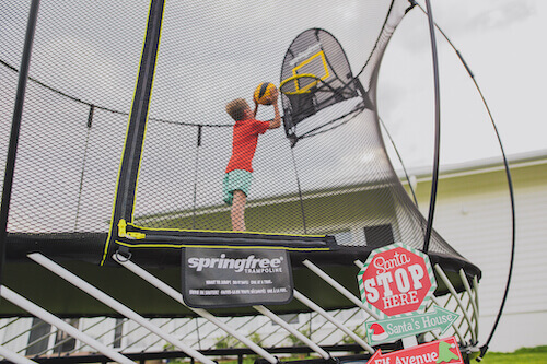 Boy playing a ball in a trampoline