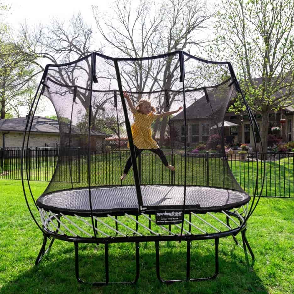 A child jumping on a Springfree Round Trampoline.