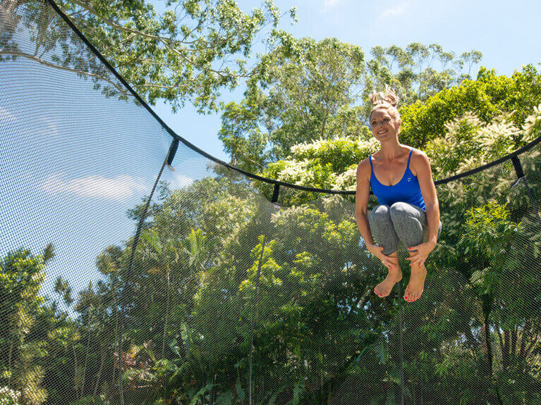 a mom jumping in a trampoline