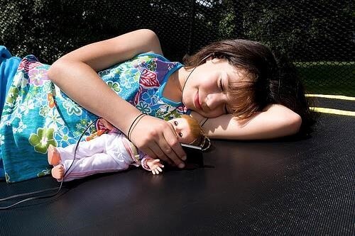Girl relaxing on trampoline