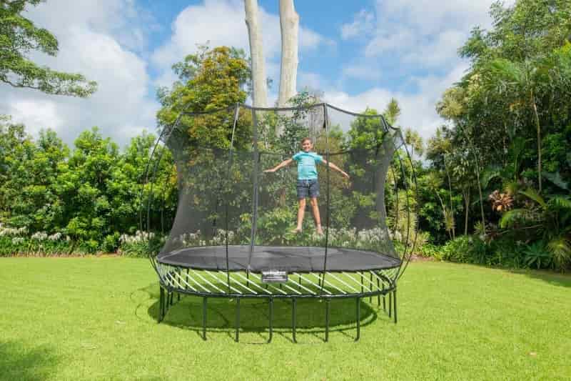 Boy jumping on a medium-sized Springfree Trampoline