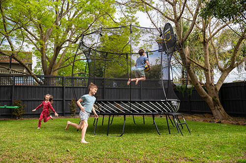 Kids playing around the trampoline