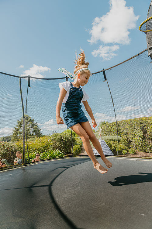 a girl jumping in a trampoline