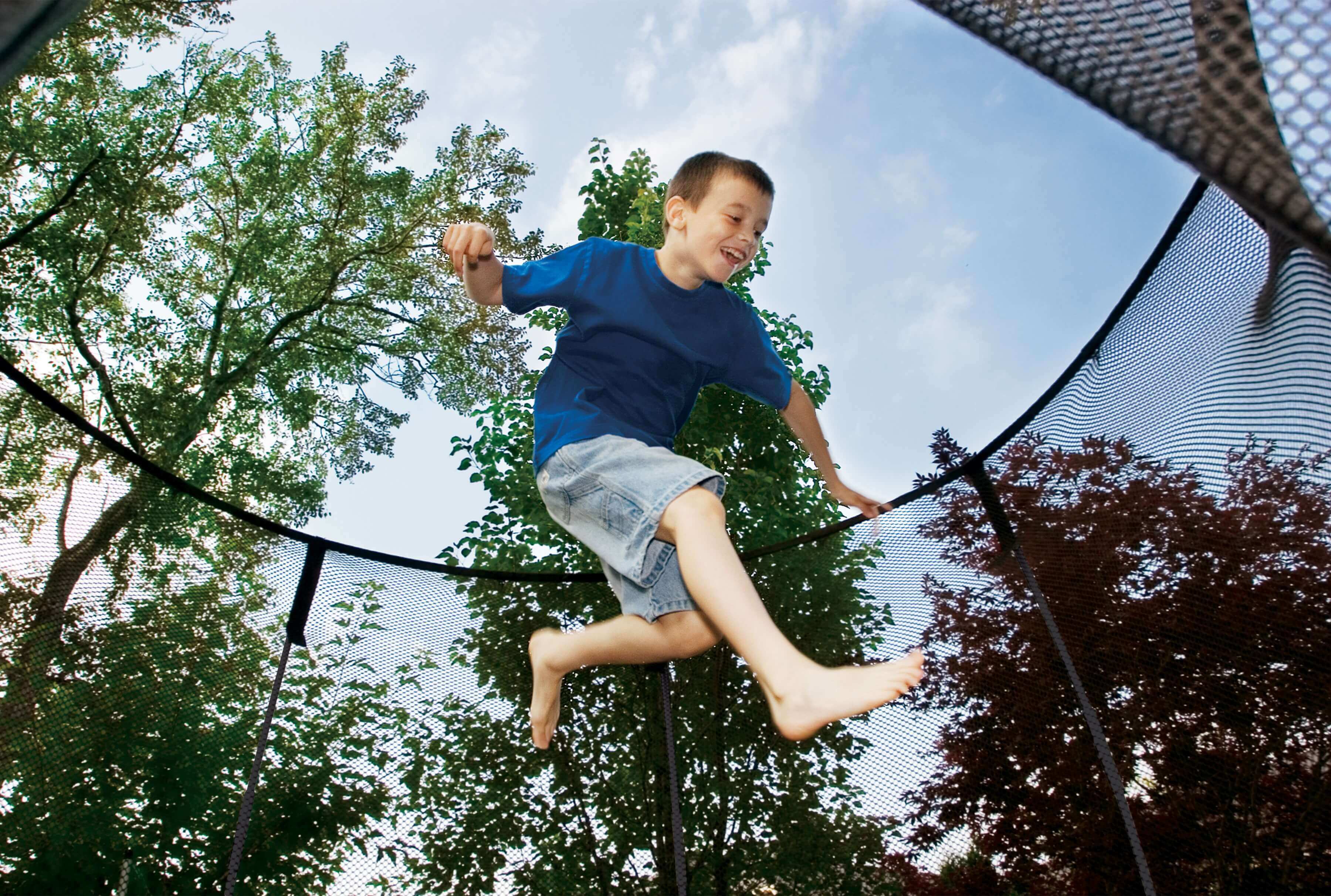 Boy jumping on trampoline
