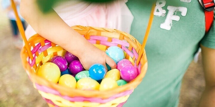a child holding Egg-cellent Easter 2022