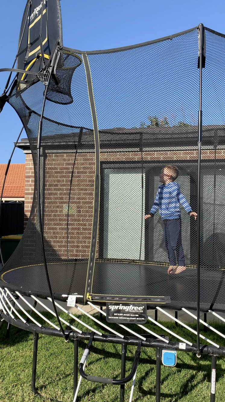 kid jumping in a trampoline