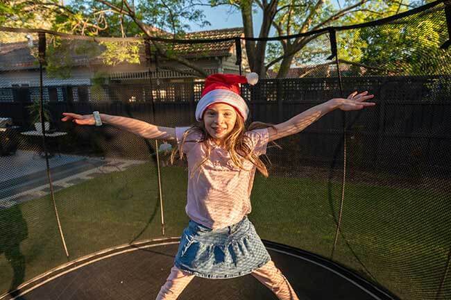 kid standing in Springfree Trampoline for Christmas