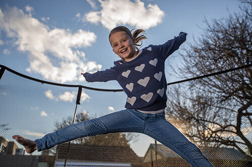 a girl jumping in springfree trampoline