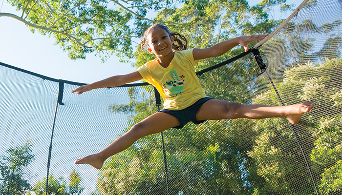 girl jumping in a trampoline
